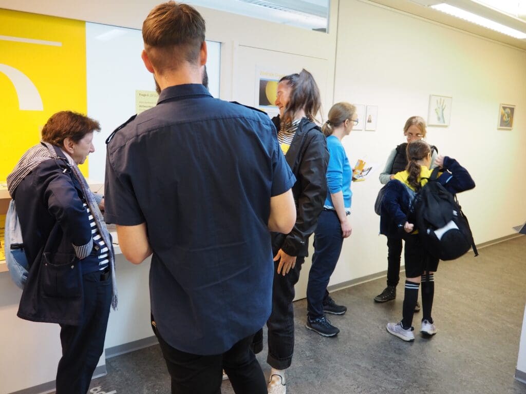 Mehrere Personen stehen in einem kleinen Kreis und sprechen lebendig miteinander.